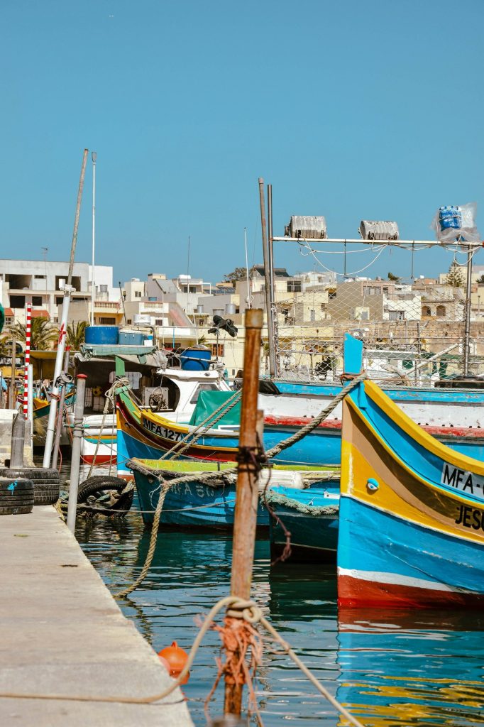 Łodzie luzzu zacumowane przy nabrzeżu w Marsaxlokk